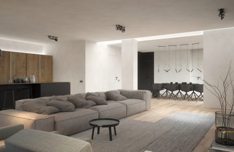 Minimalist open-plan living space with neutral tones, modern furniture, and statement lighting.