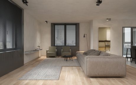 Minimalist living room with contemporary furniture, hardwood floors, and black blinds.