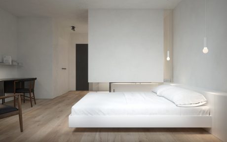 Minimalist bedroom with floating bed, wooden floor, and recessed lighting.