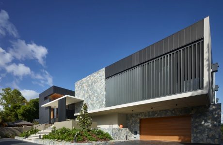 Modern architectural design with stone and steel elements, contrasting textures and shapes.