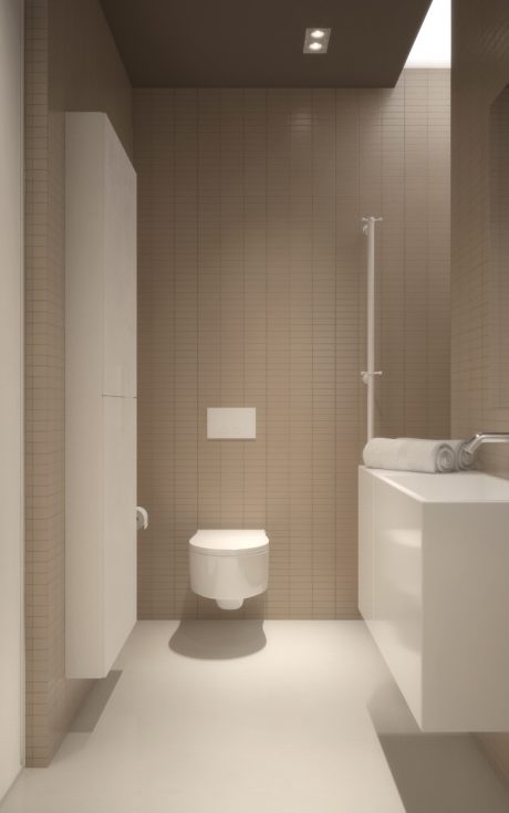 Minimal bathroom design with tile walls, toilet, and built-in vanity.