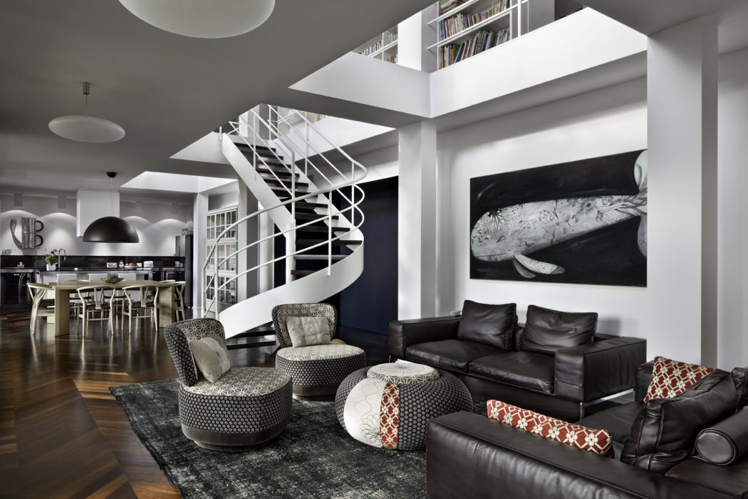 Sleek, modern interior with spiral staircase, black leather furniture, and large artwork.