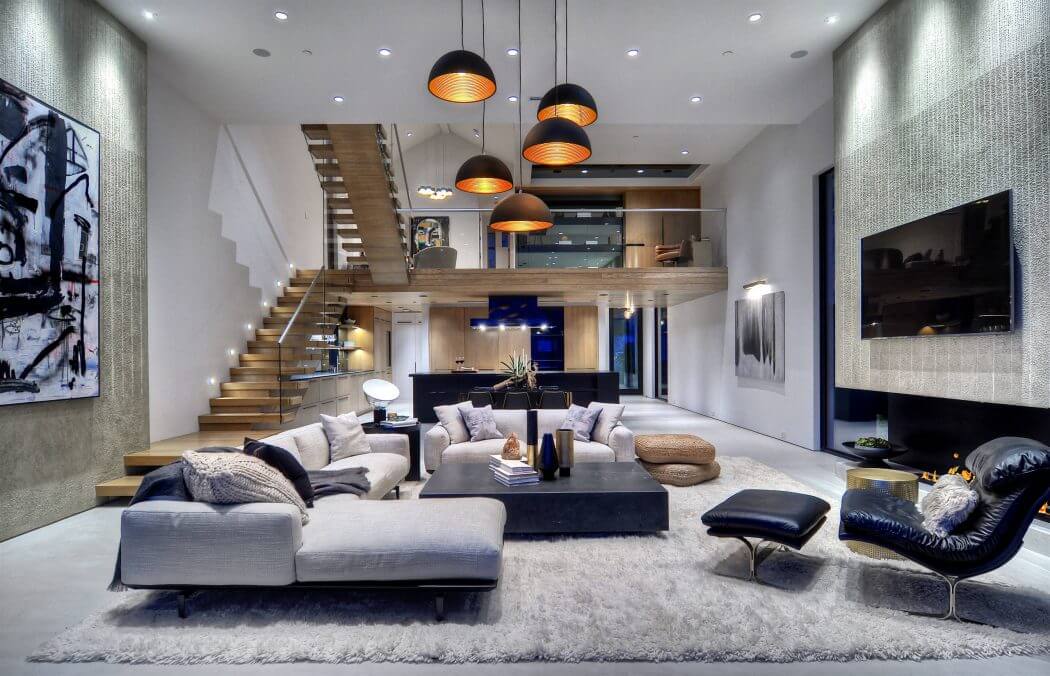 Striking contemporary living space with dramatic lighting, wood accents, and open layout.