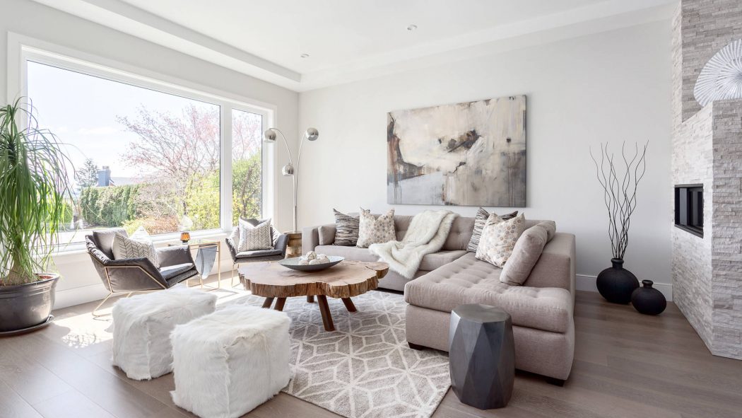Bright, modern living room with plush seating, abstract artwork, and natural textures.