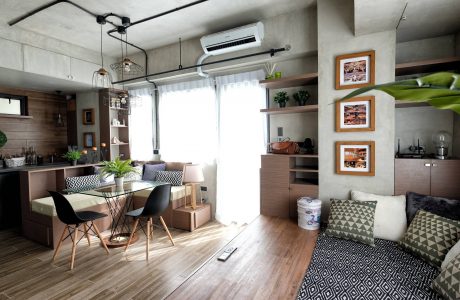 Cozy, modern apartment with chic furnishings, sleek shelving, and natural light.