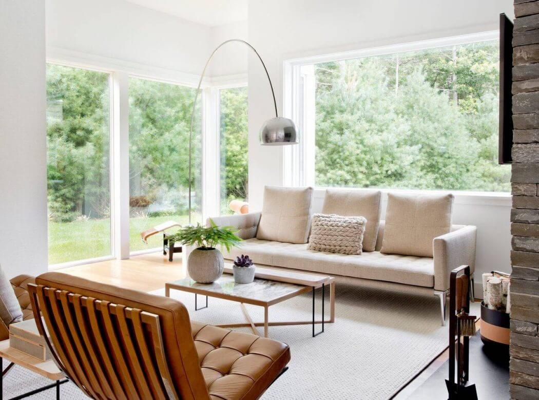 Bright, modern living room with large windows, plush seating, and minimalist decor.