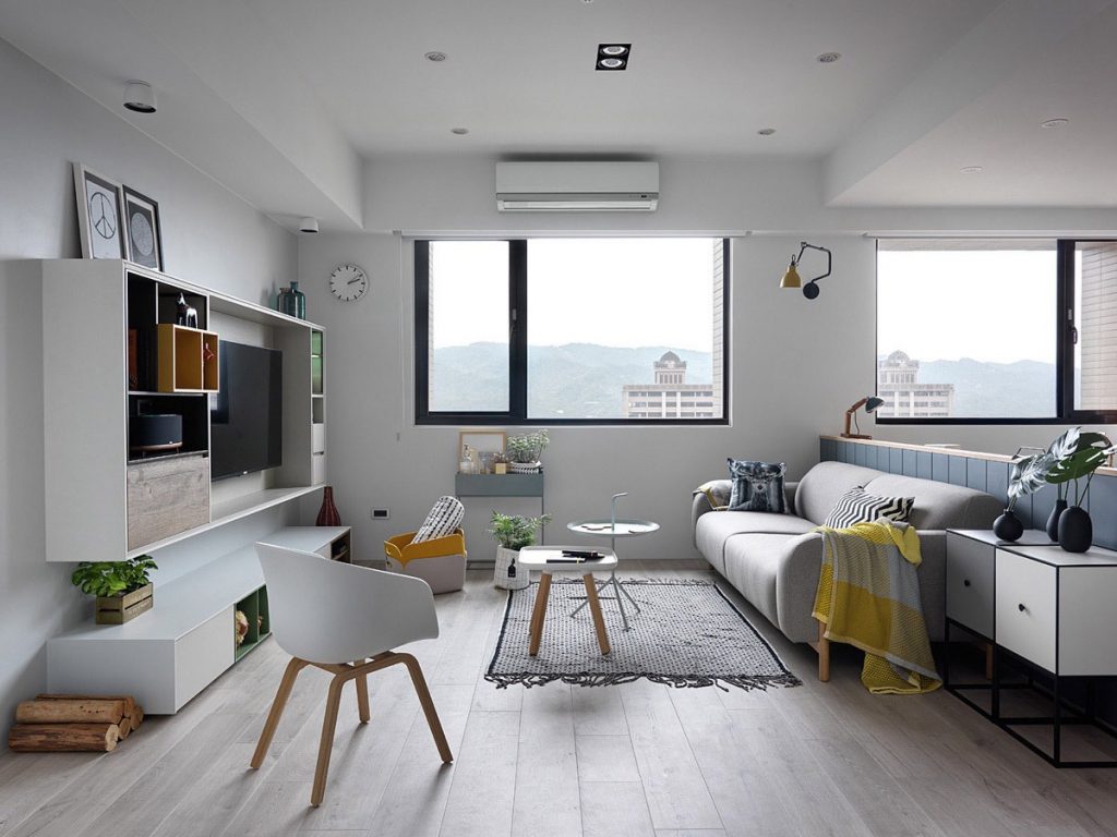 Sleek, modern living space with large window overlooking cityscape, stylish furnishings.