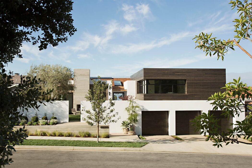 A modern, two-story home with a clean, rectangular design and a mix of wood and concrete.