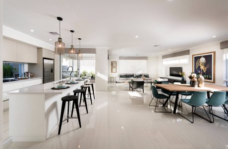 Sleek, modern kitchen with high-end appliances and an open floor plan leading to a dining area.