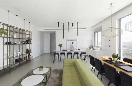 Elegant open-concept living room with sleek modern furnishings and lighting.