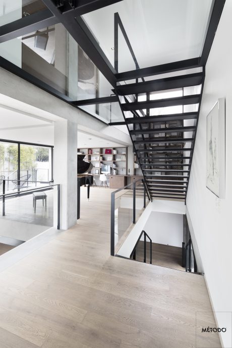 Stunning modern interior design with sleek black steel frame and glass details.