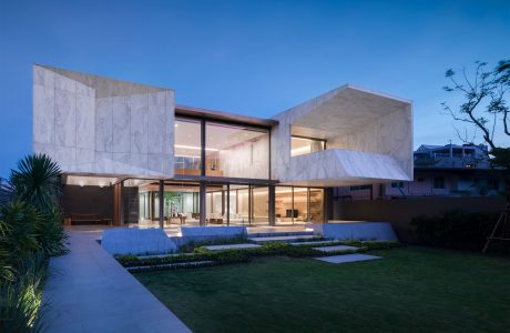 Sleek, modern house with clean lines, large windows, and well-designed landscaping.