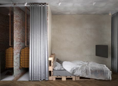 Rustic bedroom with concrete walls, pallet bed, and patterned bedding. Minimalist lighting.