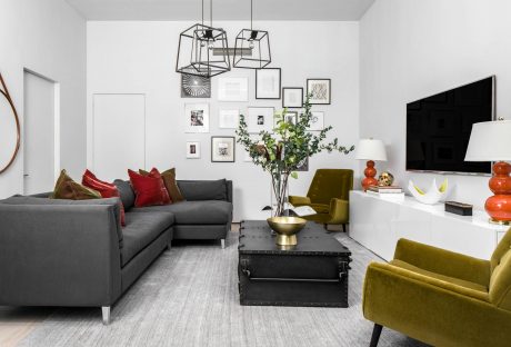 Stylish living room with modern furniture, geometric light fixtures, and gallery wall.