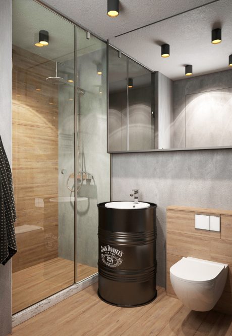 A modern bathroom with a black metal barrel sink, glass shower, and wooden accents.