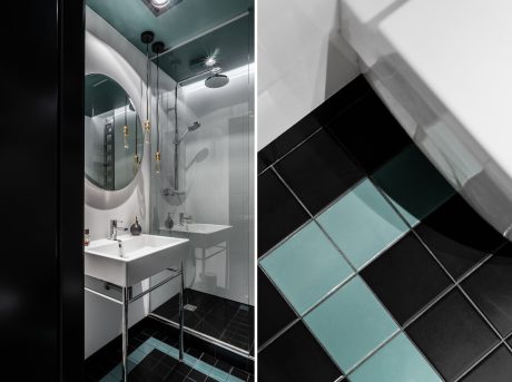 Sleek modern bathroom with stylish black and teal tile patterns, minimalist fixtures.