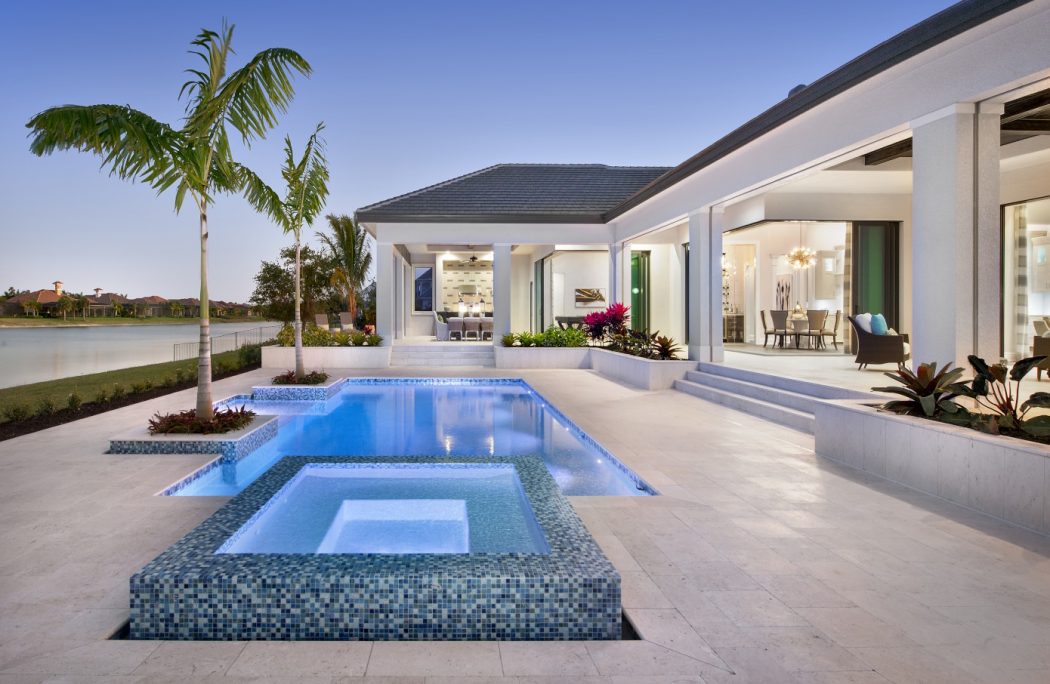 Luxurious Florida villa with modern pool, hot tub, and covered outdoor living area.