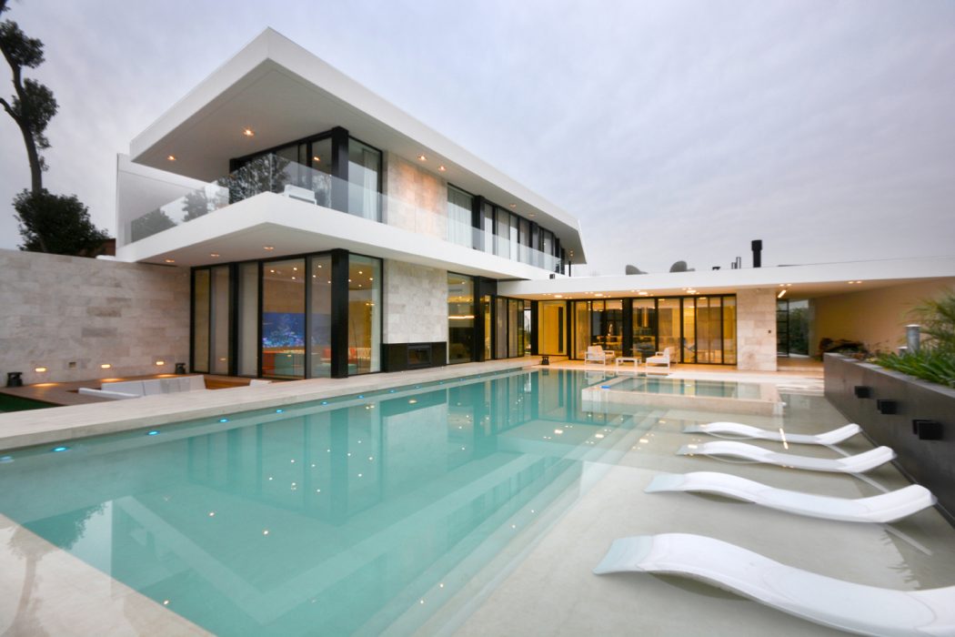 Sleek, modern architecture with a spacious, open-concept design and a luxurious pool.