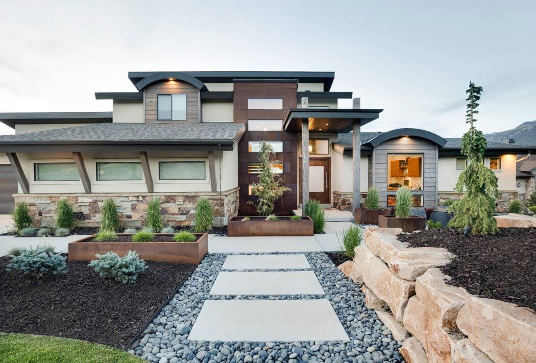 Sleek, contemporary home featuring clean lines, stone accents, and thoughtfully-designed landscaping.