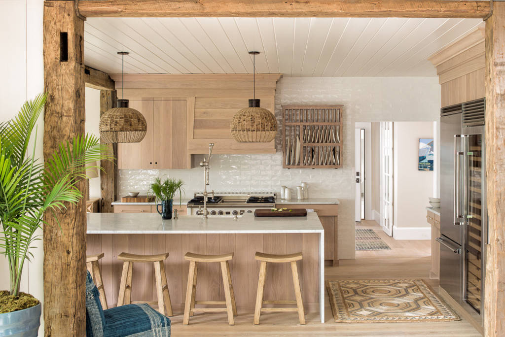 Charming rustic kitchen with wooden beams, pendant lights, and modern appliances.