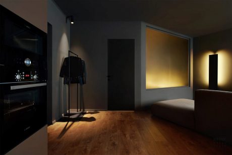 Dark, moody interior with wooden floor, illuminated wardrobe, and glowing window.