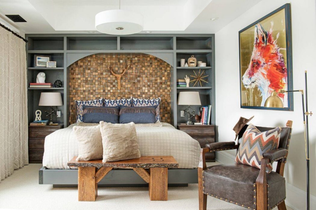 Rustic bedroom features a wooden mosaic headboard, built-in shelving, and contemporary furnishings.