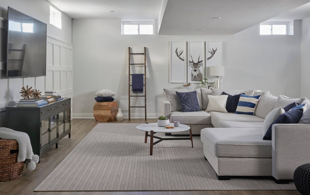 Spacious living room with modern furnishings, deer-themed artwork, and neutral color palette.