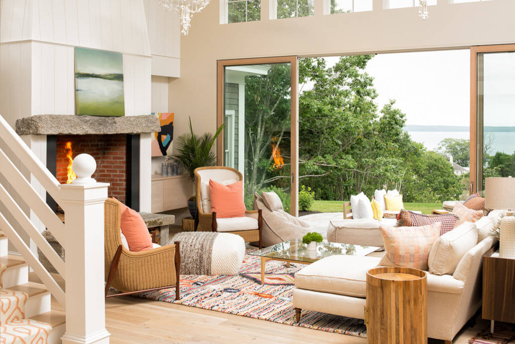 Cozy living room with a brick fireplace, plush seating, and large windows overlooking the outdoor scenery.