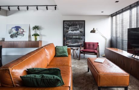 Modern living space with sleek furniture, artwork, and lighting fixtures.