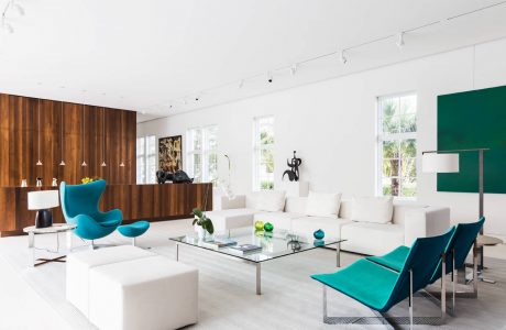 Bright, modern living room with sleek furniture, wooden accents, and large windows.