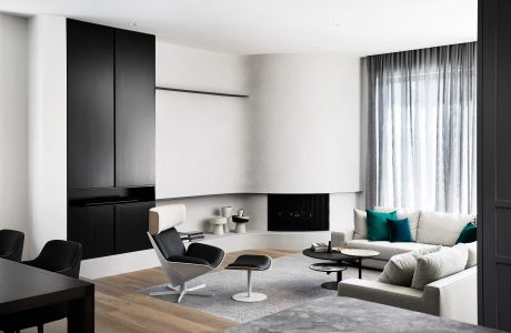 Sleek, minimalist living room with monochrome color scheme, modular furniture, and large windows.