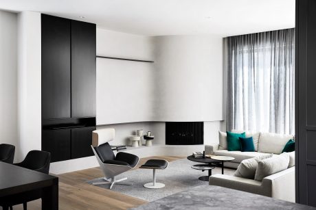 Sleek, minimalist living room with monochrome color scheme, modular furniture, and large windows.