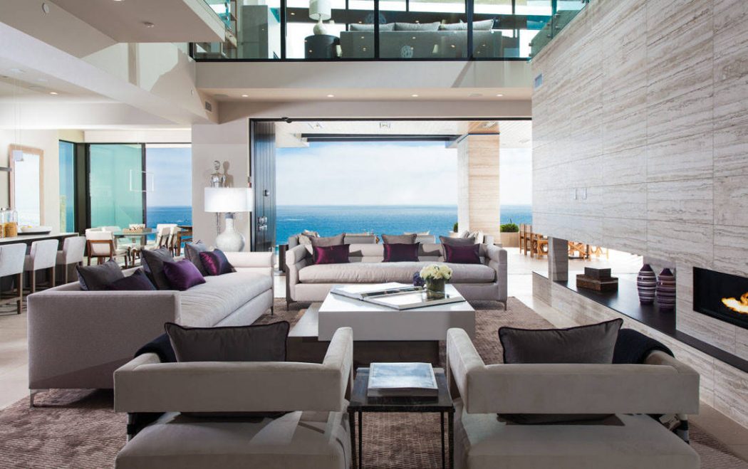 Expansive living room with floor-to-ceiling windows offering breathtaking ocean views.