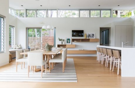 Expansive open-plan living area with abundant natural light, modern furniture, and wood accents.