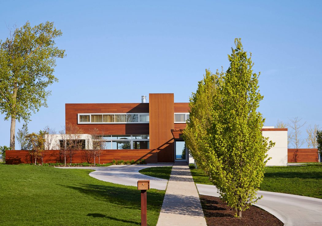 Modern architecture with warm wood accents, large windows, and well-landscaped surroundings.