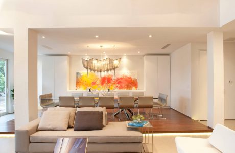 Sleek, modern living space with bold abstract art, contemporary furniture, and warm lighting.