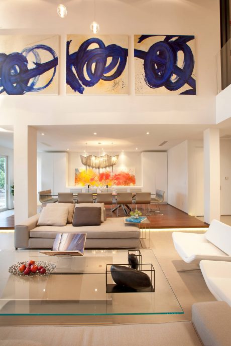 Sleek, modern living space with bold abstract art, contemporary furniture, and warm lighting.