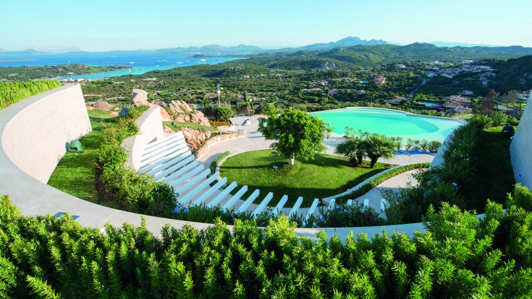 Stunning, terraced outdoor amphitheater surrounded by lush foliage and turquoise pool.