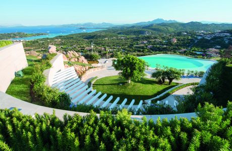 Stunning, terraced outdoor amphitheater surrounded by lush foliage and turquoise pool.