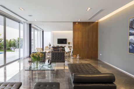 Minimalist and modern interiors with sleek glass, wood, and leather furnishings.