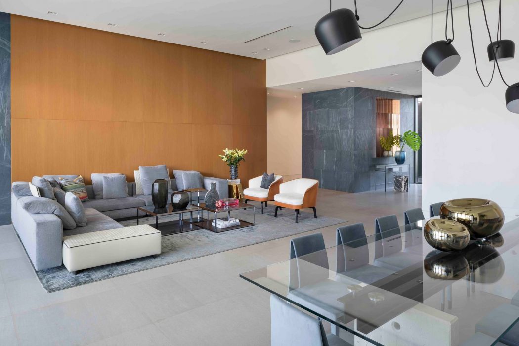 Spacious open-concept living area with sleek, modern furnishings and lighting elements.