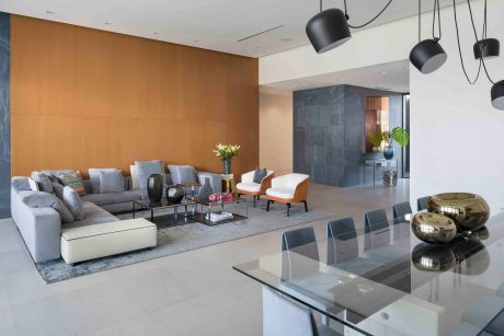 Spacious open-concept living area with sleek, modern furnishings and lighting elements.