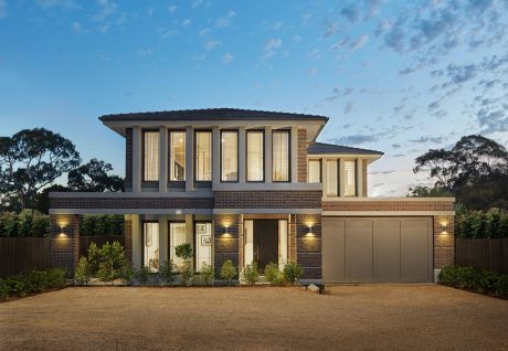 Elegant two-story brick house with large windows, porch, and landscaped yard.