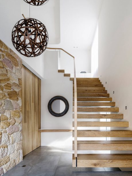 Stunning modern staircase with wooden treads and minimalist design elements.