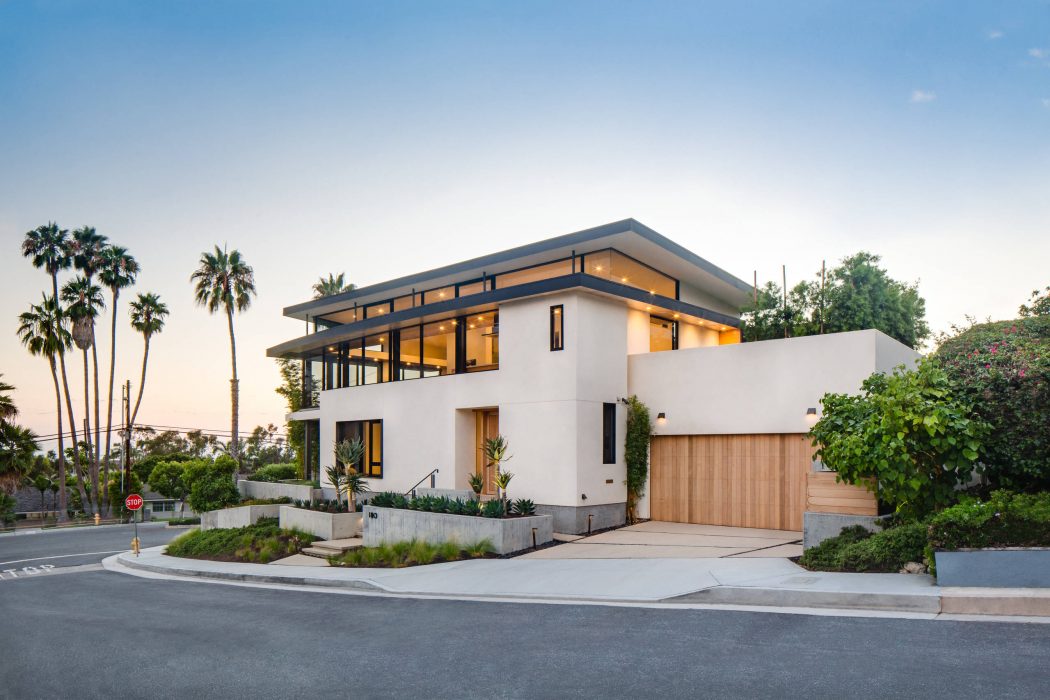 Sleek, modern house with clean lines, large windows, and a garage door blend seamlessly.