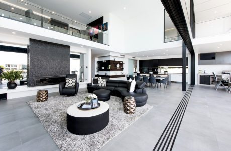 Luxurious open-concept living space with sleek black-and-white decor, high ceilings, and modern furnishings.