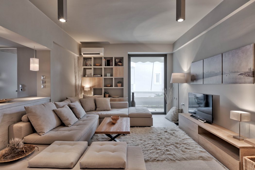 Spacious living room with sleek modern design, large sectional sofa, and built-in shelving.