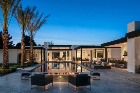 Sleek modern architectural design with a tranquil reflecting pool and lounge area.