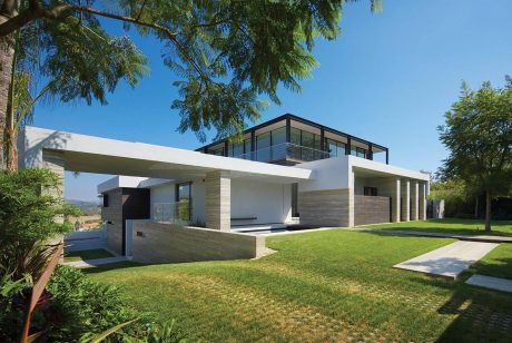 Sleek modern home with clean lines, large windows, and lush landscaping.