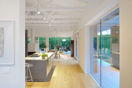 An open-concept kitchen flows seamlessly into a spacious living area with abundant natural light.